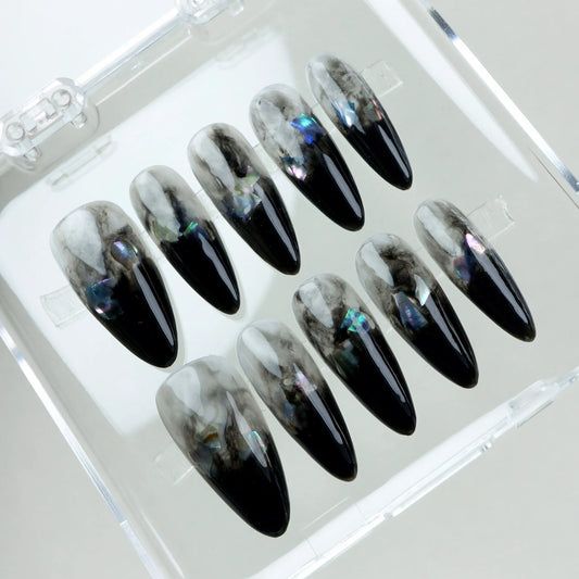 Mystical and moody—these nails blend swirling grey smoke with glossy black tips and hints of iridescent shimmer.