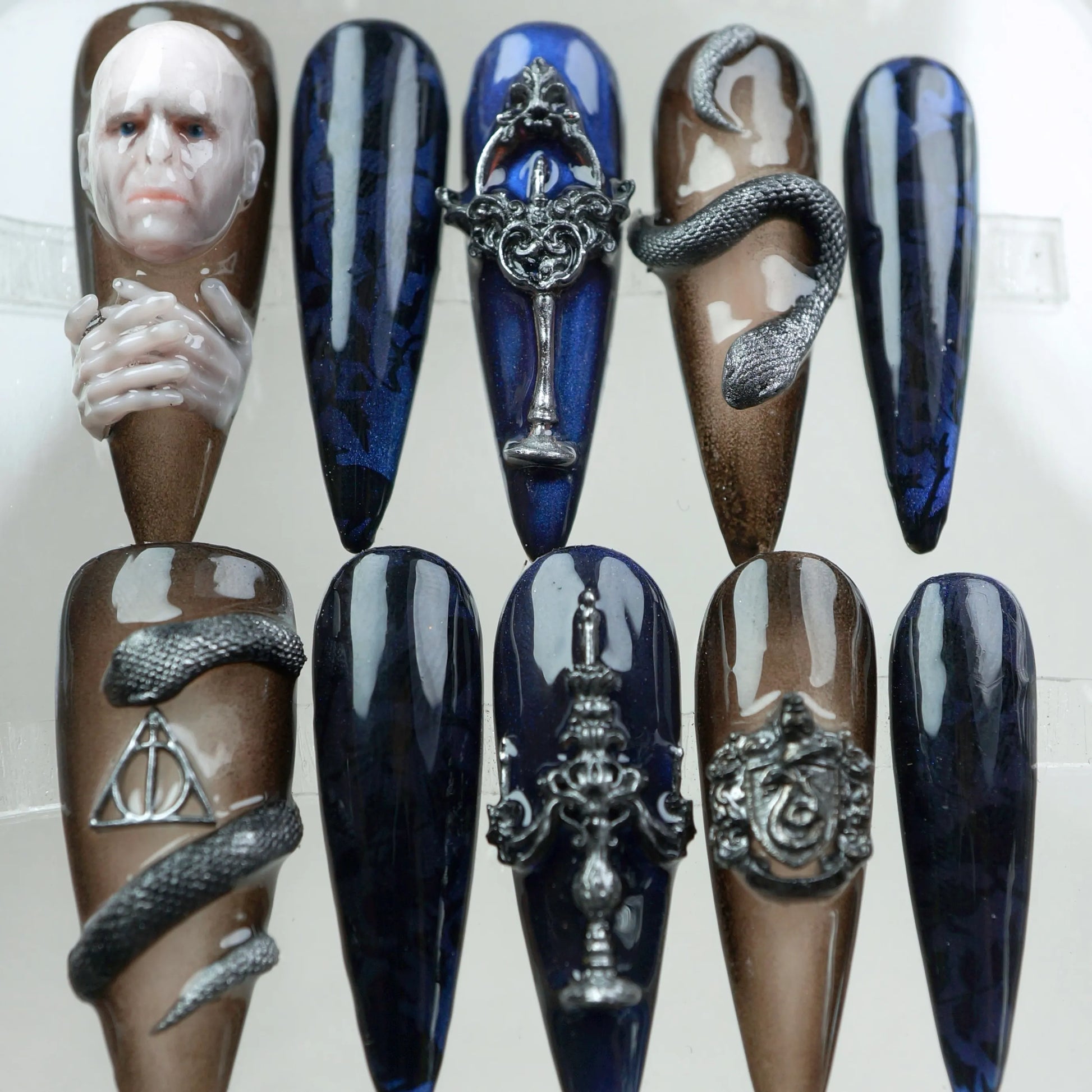 Luxury press-on nails with Harry Potter dark art references, including Deathly Hallows and gothic symbols