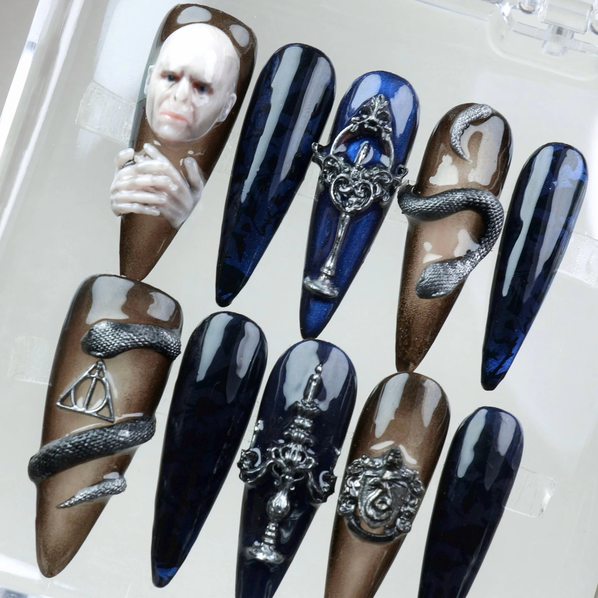 Luxury press-on nails with Harry Potter dark art references, including Deathly Hallows and gothic symbols