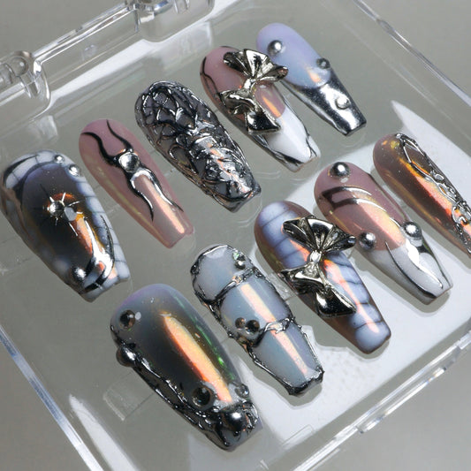 Iridescent pink and silver press-on nails by Donailsart, designed with futuristic metallic vibes and bold chrome elements.