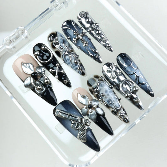Edgy press-on nails with sculpted silver details, skulls, crosses, and gun art – a bold Donailsart design.