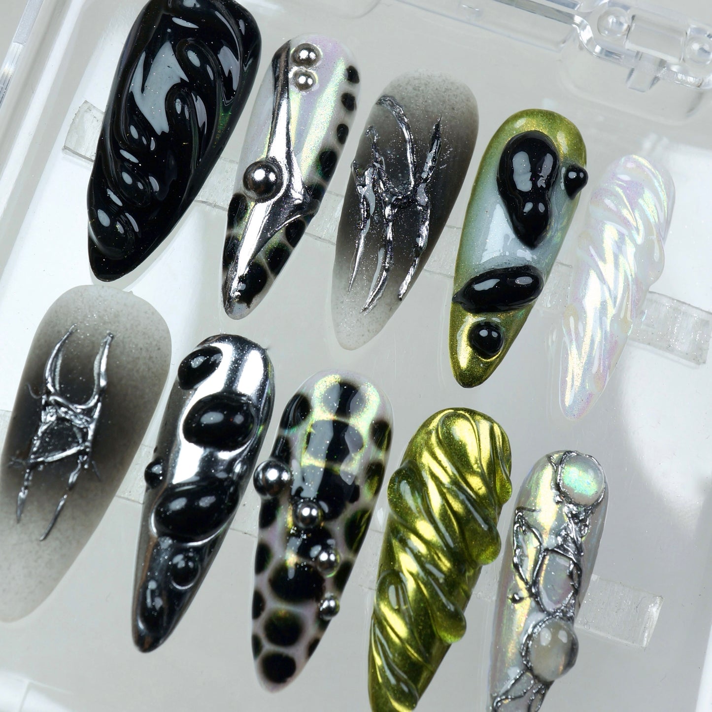 Aliencore-inspired press-on nails with slime-like blobs, reflective chrome, and Y2K metallic vibes.