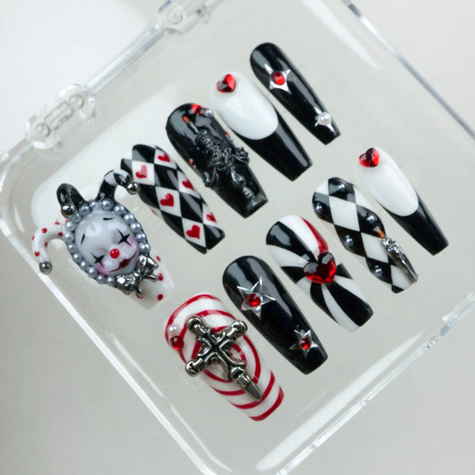Bold black, white, and red press-on nails featuring jester motifs, gothic details, and heart embellishments from Donailsart.