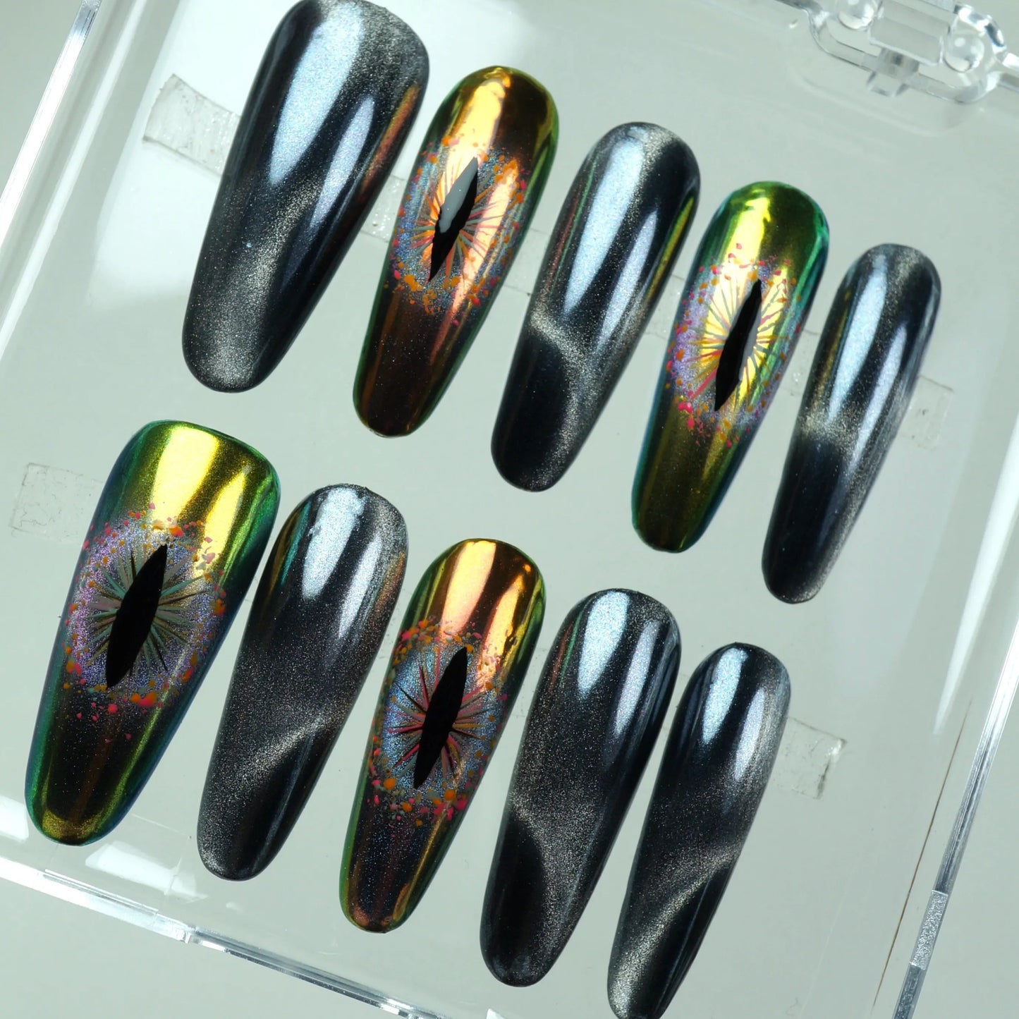 Donailsart press-on nails with multichrome reptilian eyes and metallic cat-eye effects for a hypnotic, sci-fi look