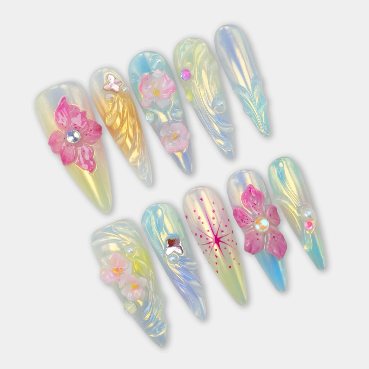 Summer flower nails with iridescent pastel base, 3D floral embellishments, and glossy rainbow shimmer by Donailsart