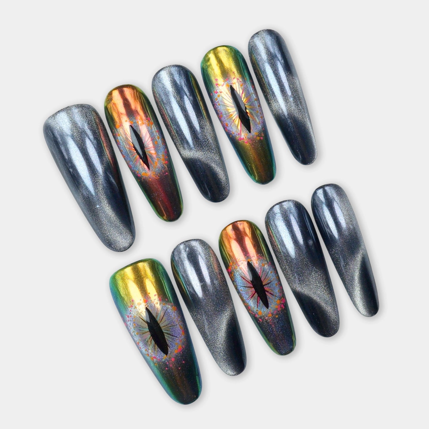 Press-on nails featuring black cat-eye magnetic shimmer and holographic reptile-eye designs in green and gold chrome by Donailsart