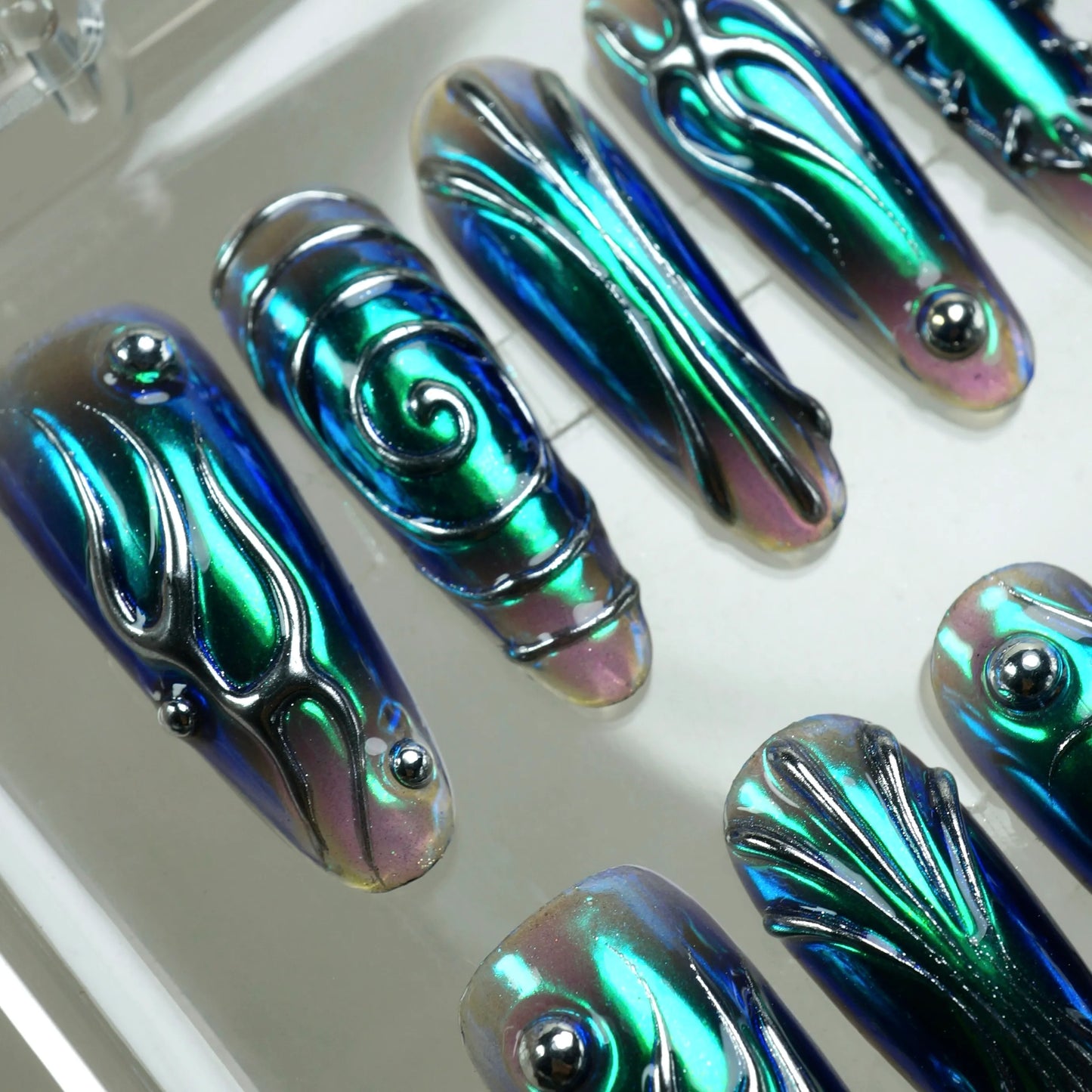 Iridescent nail art designs on a white background