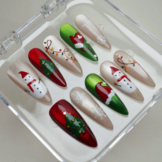 Set of Christmas-themed nail art designs in a clear case.
