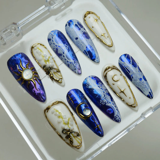 Celestine Sovereign press-on nails on display showing the full cobalt chrome and gold celestial lace nail art collection – Donailsart