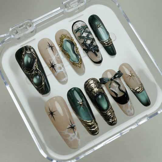 Velour Noire press-on nails on display showing the full emerald cat-eye and gold lace nail art collection – Donailsart