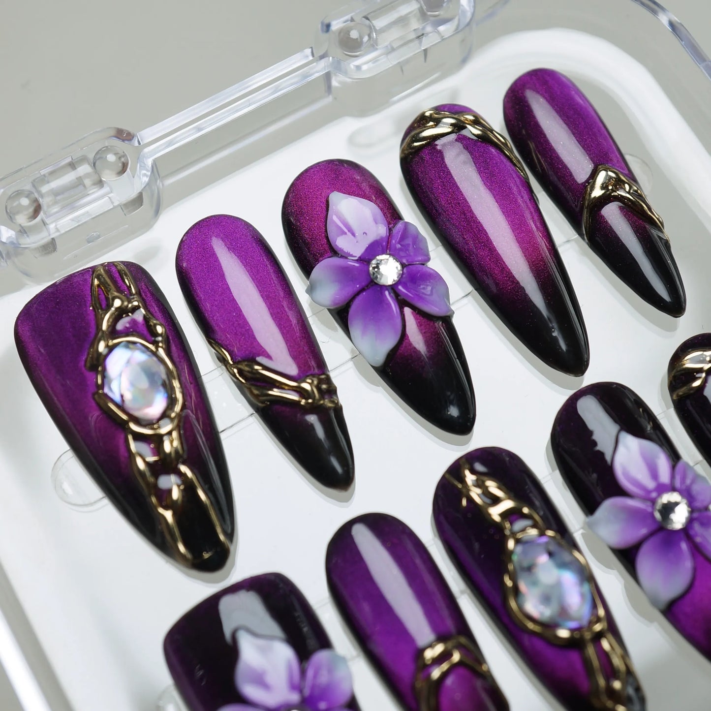 Veloria press-on nail set product view with bold deep amethyst, gold, and gemstone statement nail art by Donailsart