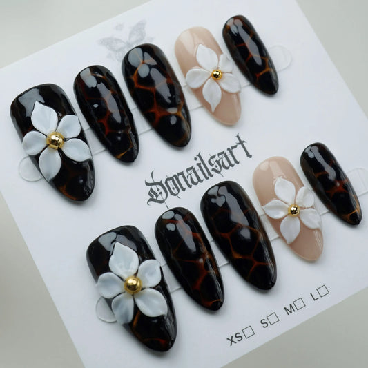 A15 | Black Marble press-on nails on display showing the full black marble and white floral nail art collection – Donailsart
