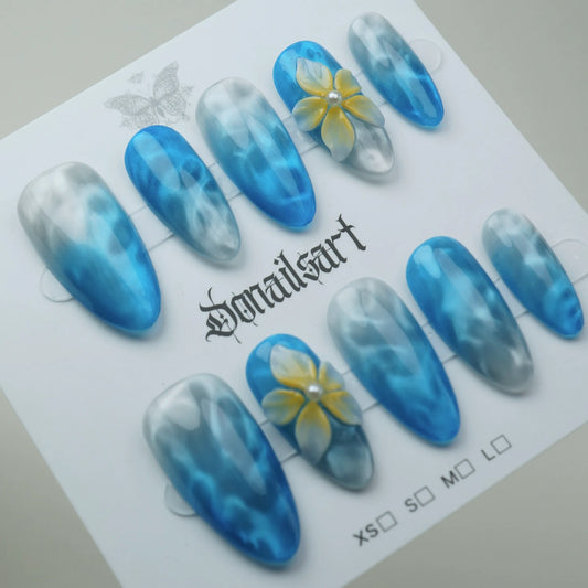 A21 | Sea Mist Flower press-on nails on display showing the full soft blue ocean mist floral nail art collection – Donailsart
