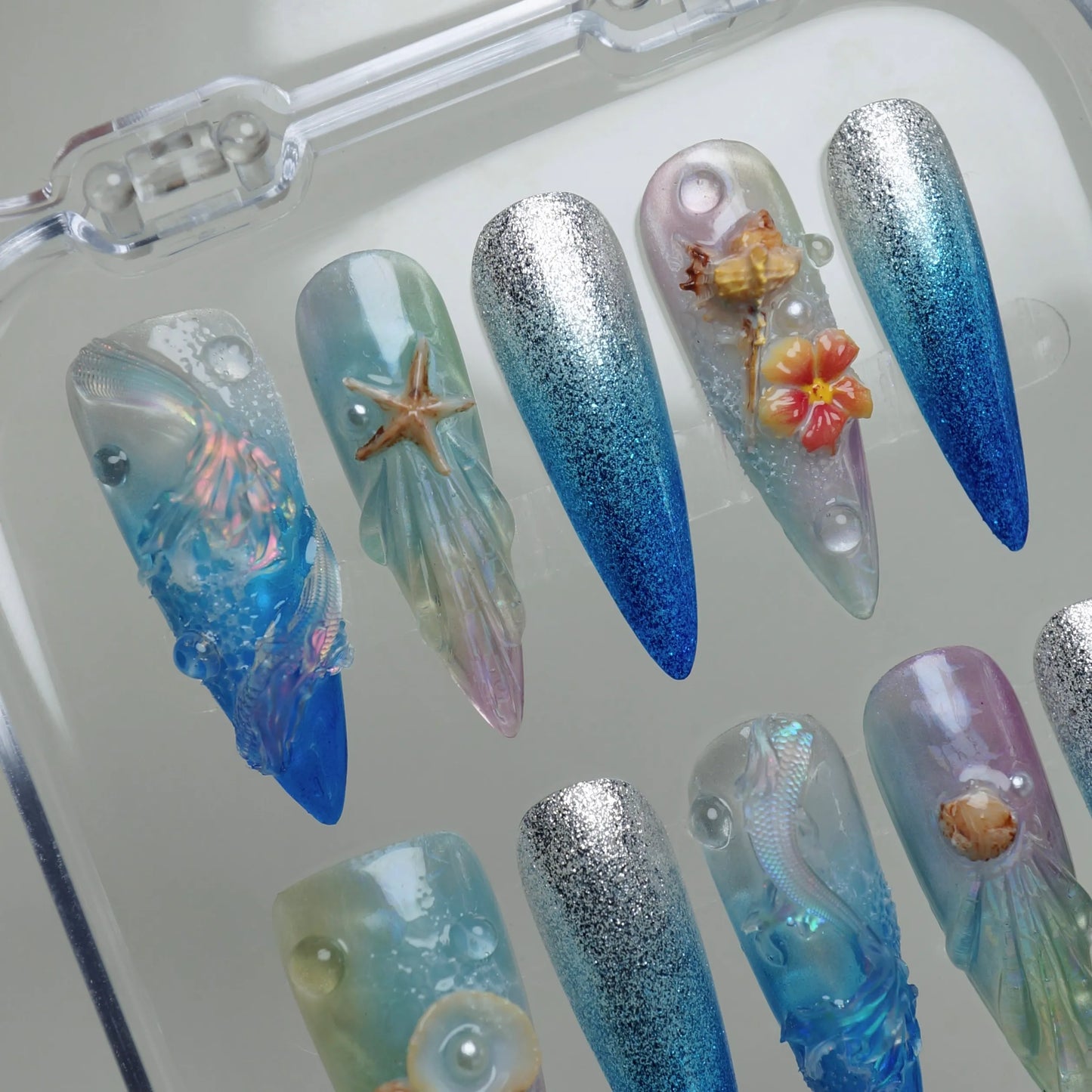 Aqualume press-on nail set product view with luminous translucent underwater iridescent nail art by Donailsart