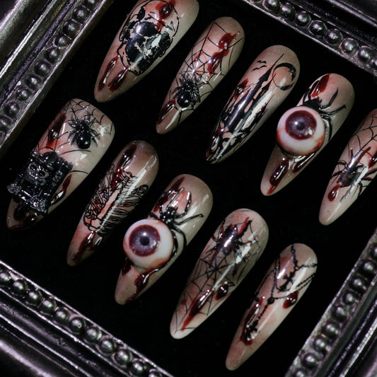 Creeping Gaze press-on nails, angled close-up of 3D eyeballs and skulls