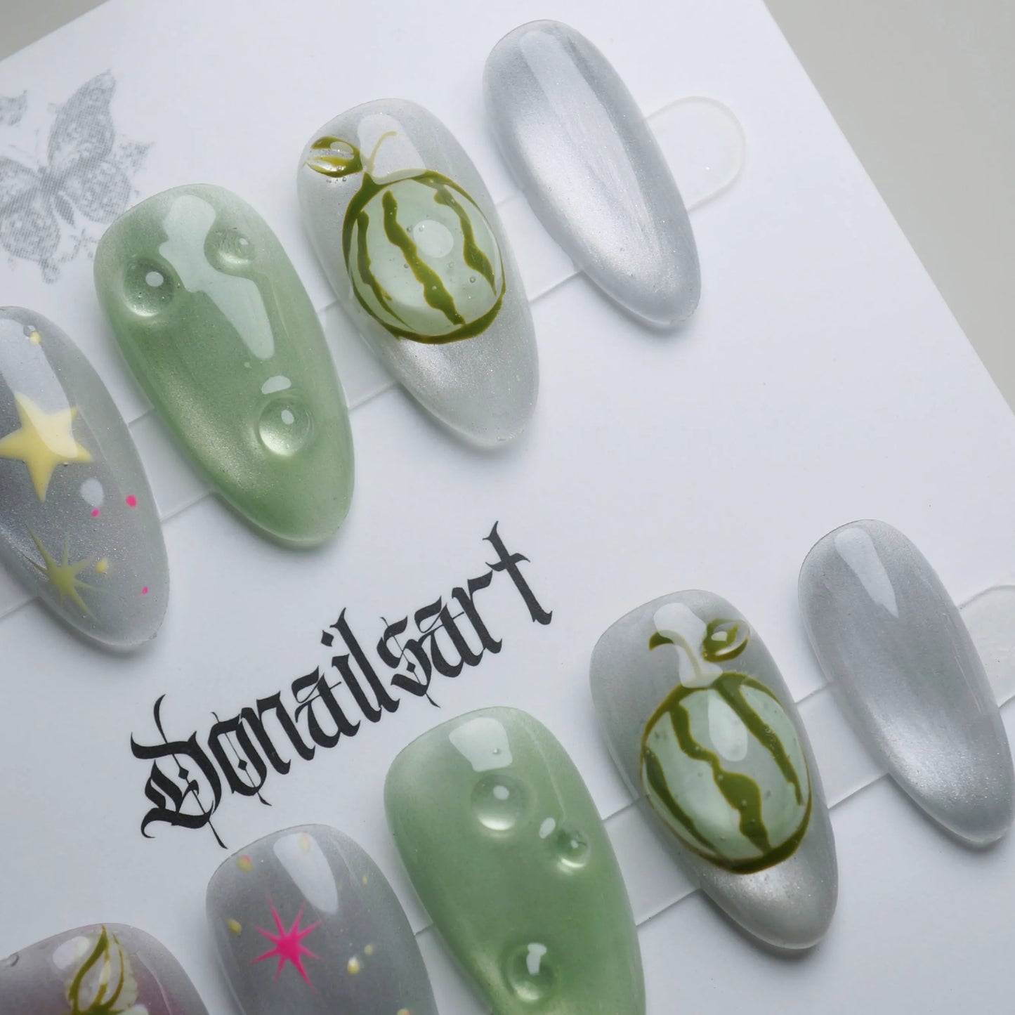 A26 | Melon Mirage press-on nail set product view with vivid surreal neon fruit and chrome star nail art by Donailsart