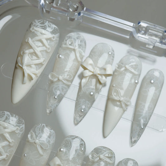 Ivory Keepsake press-on nails on display showing the full elegant lace and bow nail art collection – Donailsart