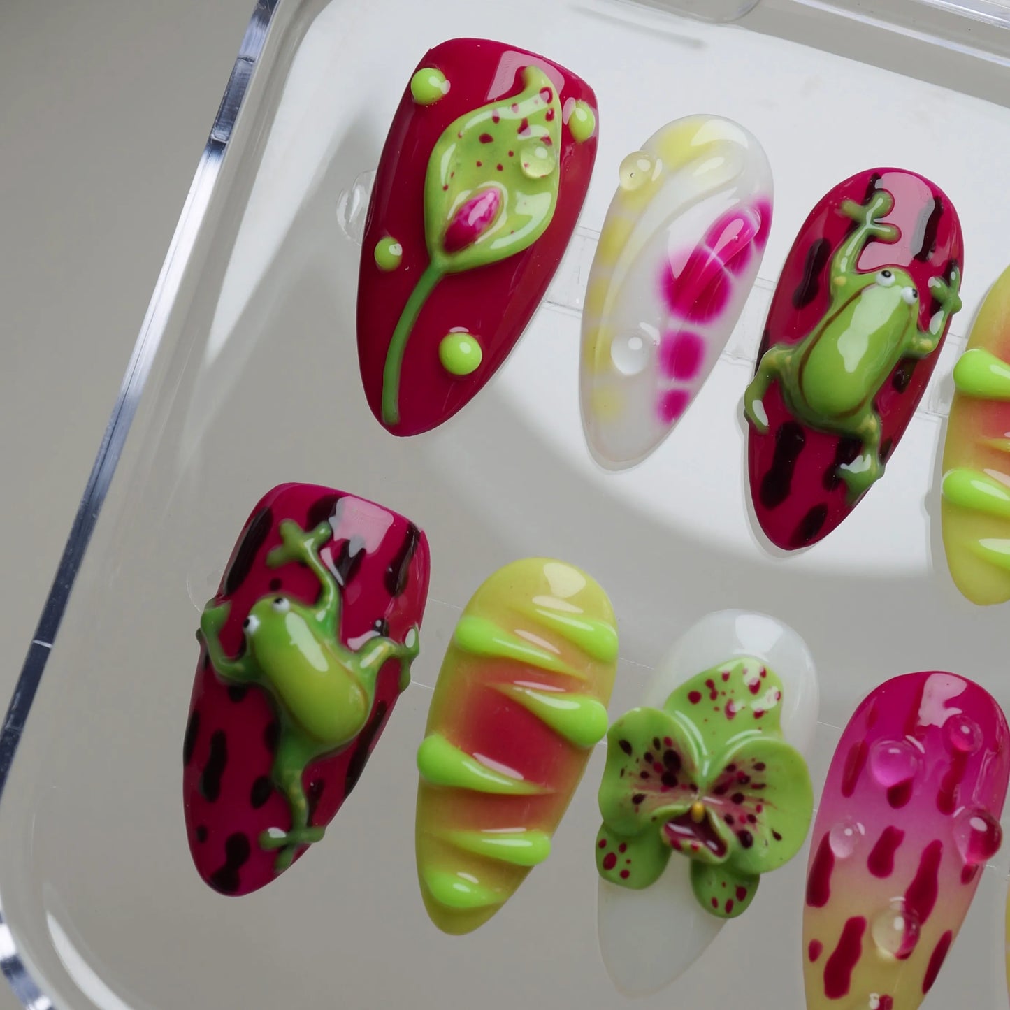 Colorful nail art designs on a white tray