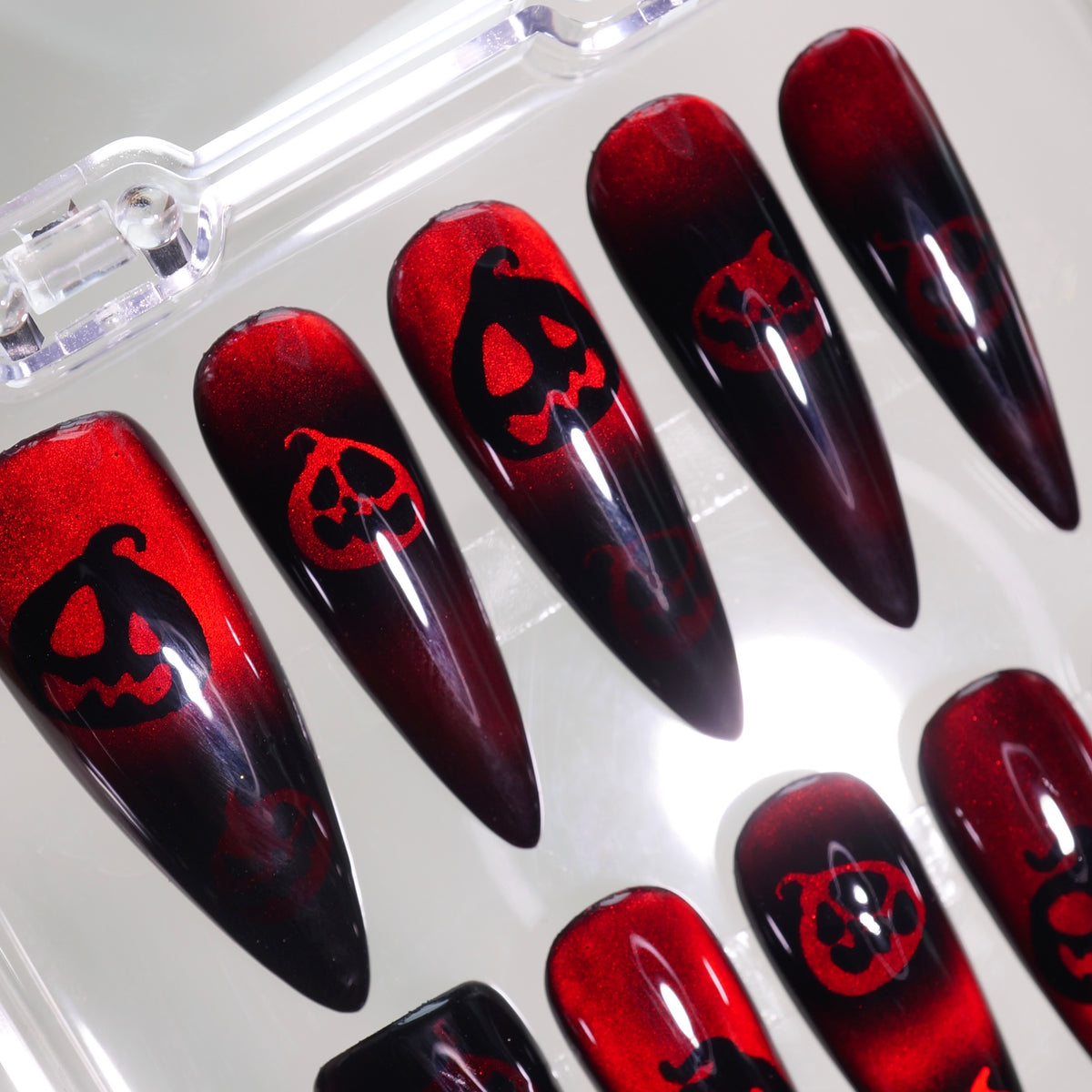 Pumpkin Curse press-on nails, close-up on a white background