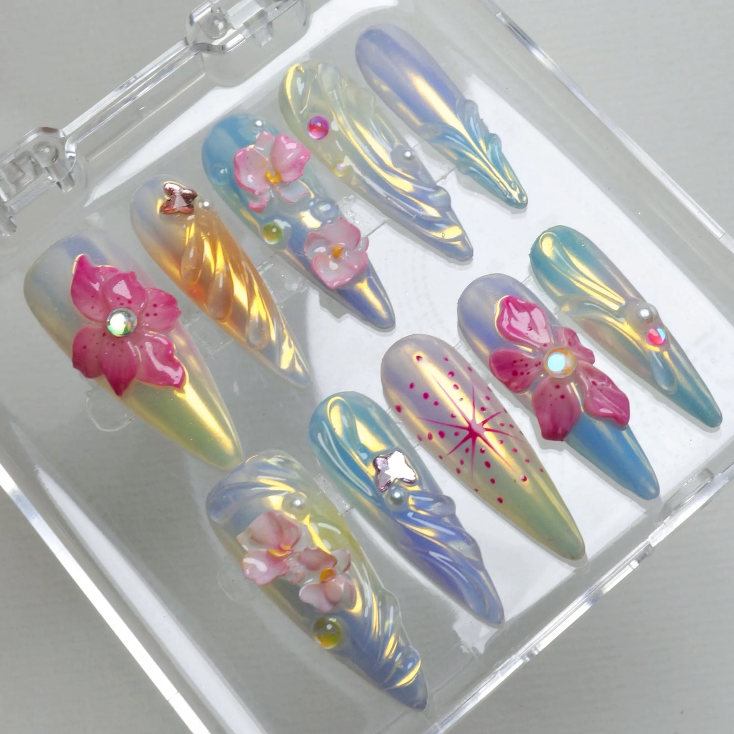 Donailsart summer flower nails featuring sculpted pink blossoms, pearl accents, and glowing opalescent finishes