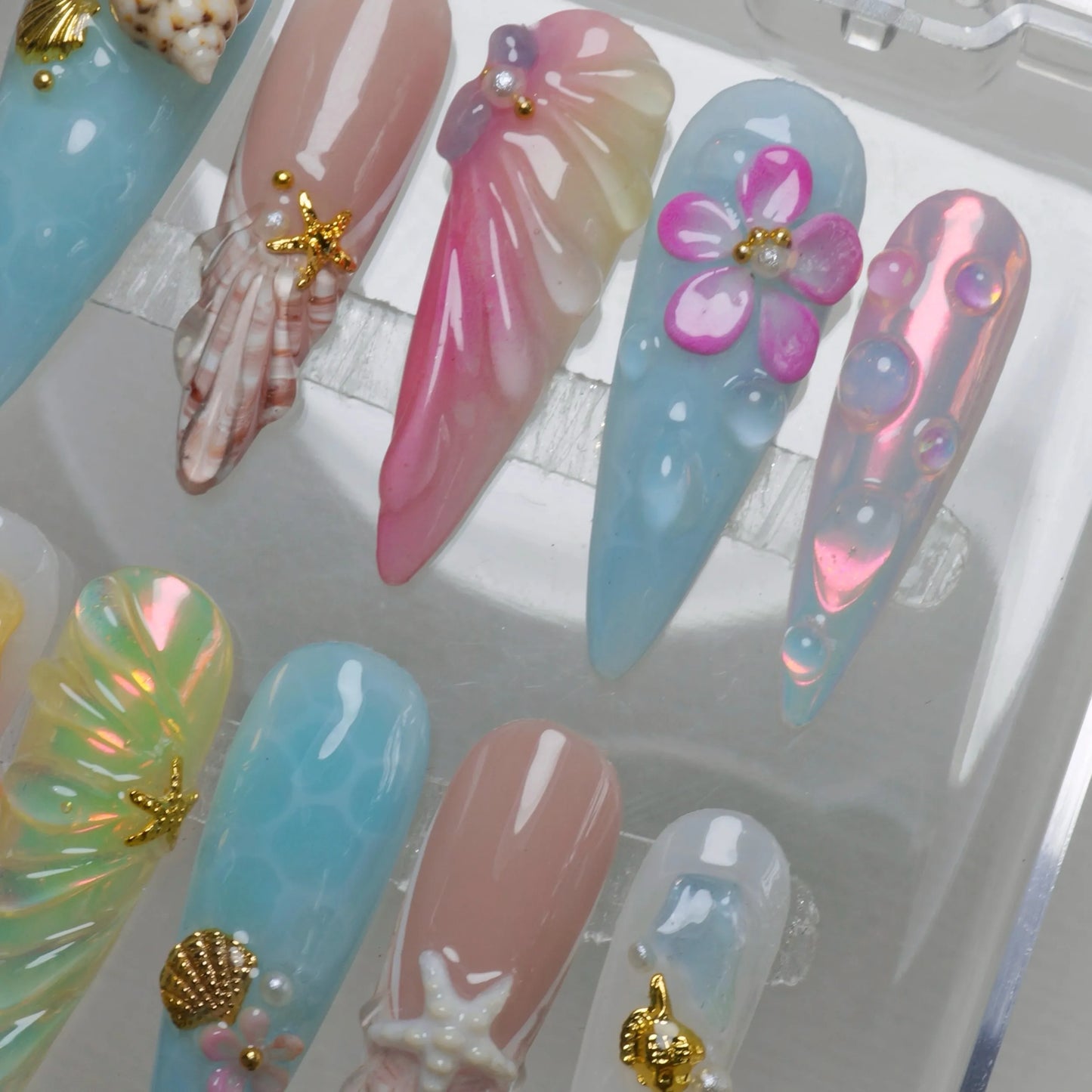 Donailsart summer nails in pastel hues with seashells, jellyfish textures, and sunlit shimmer