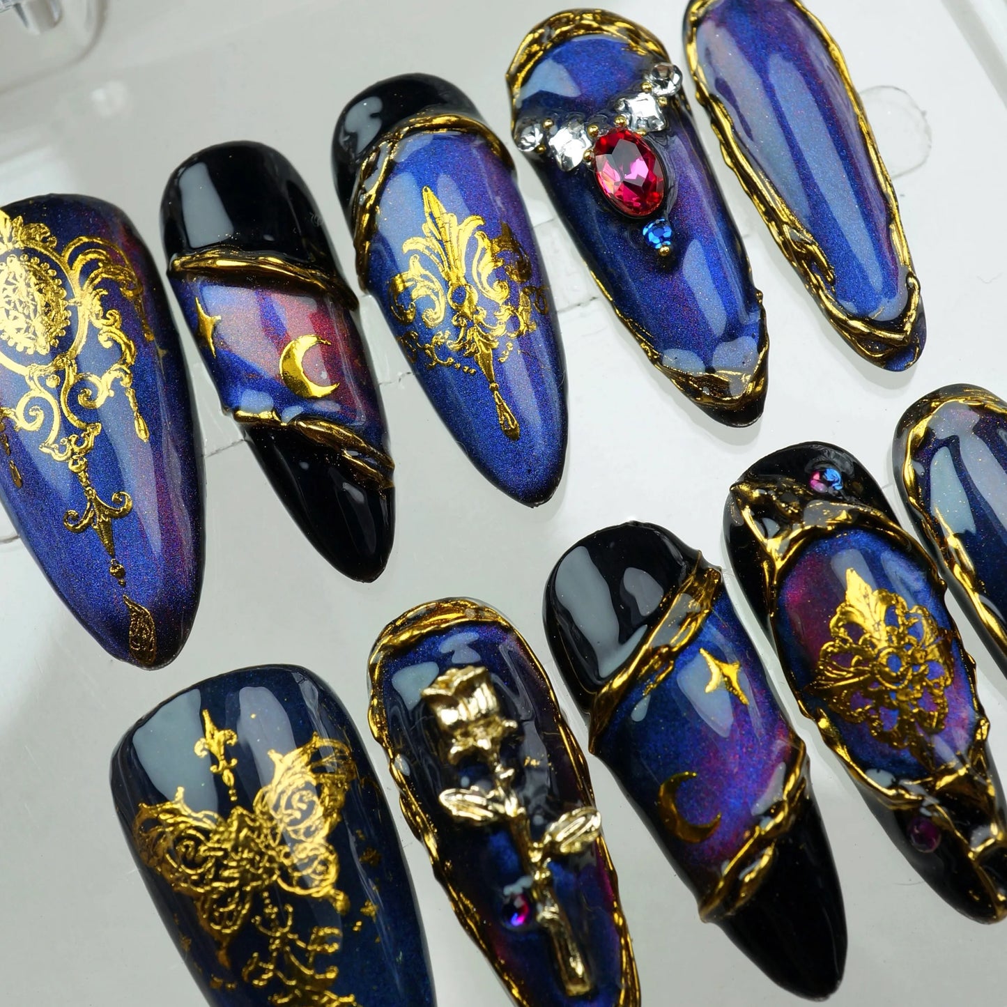 Donailsart press-on nails with dark blue-purple chrome, gothic cross charms, and celestial gold foil accents