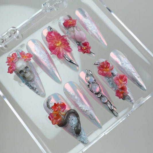 Bold summer nails art featuring holographic shimmer, flaming flowers, and gothic details like skulls and serpents
