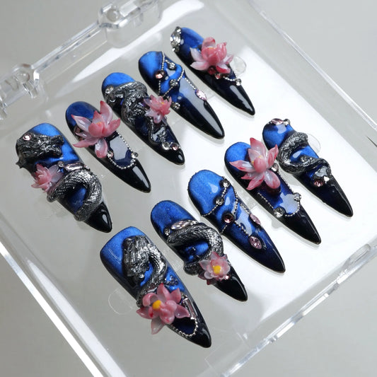 Fantasy nails art featuring 3D dragons, blooming lotuses, and gemstone chains on midnight blue press-ons