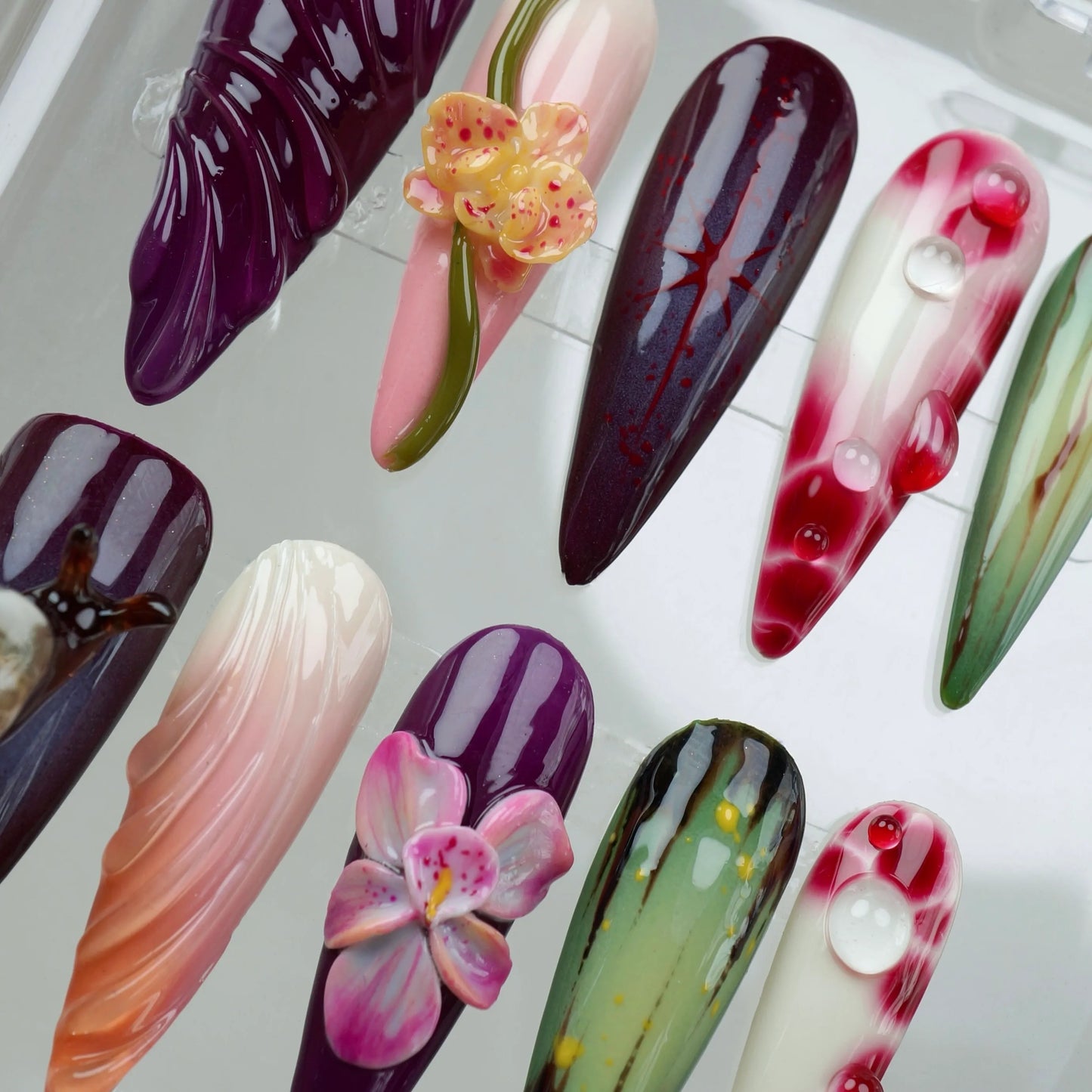 Exotic flower design nails with nature-inspired colors and details, perfect for a lush vacation-ready nail set