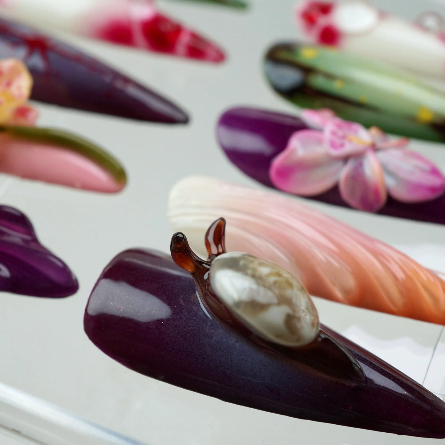 Unique flower design nails blending earthy tones with bold textures, showcasing floral art and nature-inspired detailing