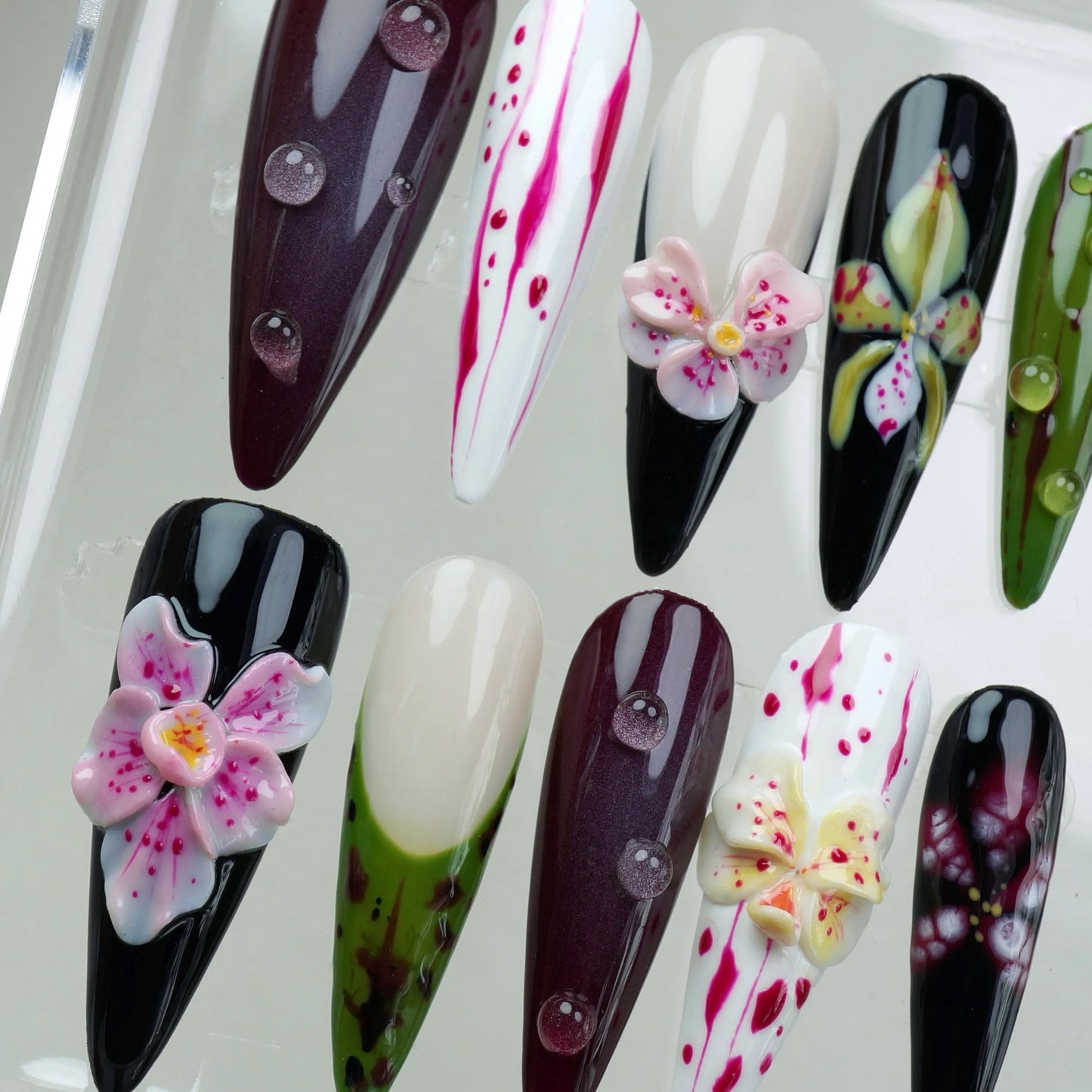 Bold flower design nails with dramatic color contrasts, featuring 3D floral elements and abstract petal streaks