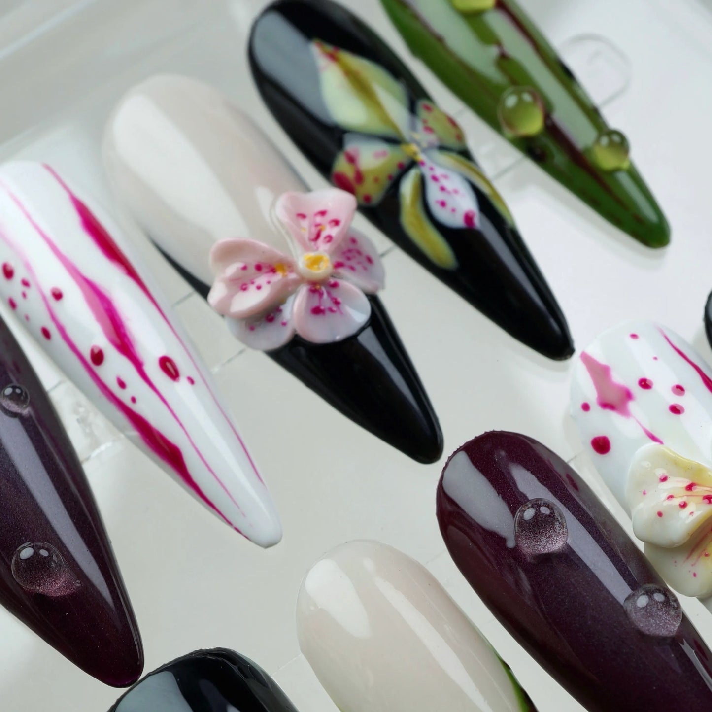Creative flower design nails with a moody garden vibe, combining hand-painted flower art and 3D blossoms for texture