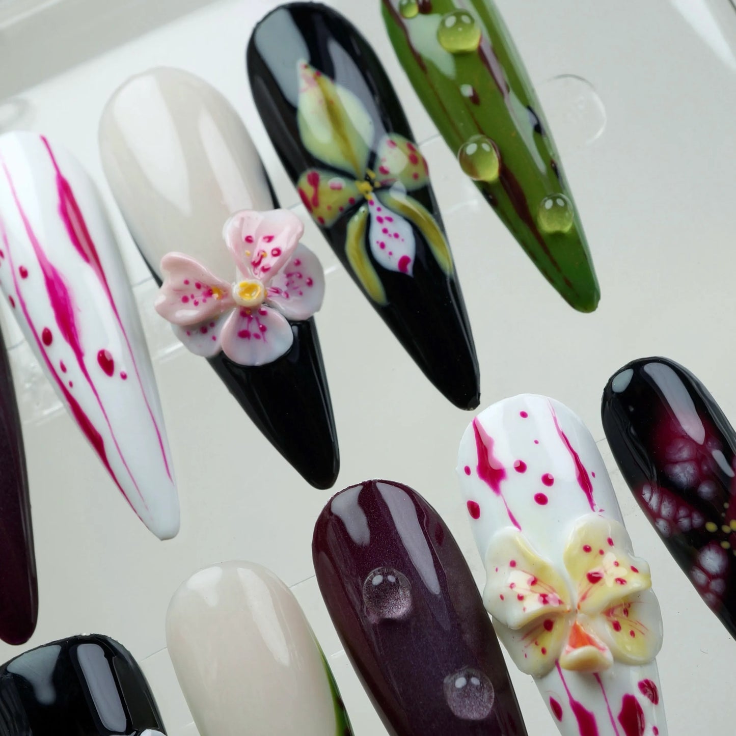 Creative flower design nails with a moody garden vibe, combining hand-painted flower art and 3D blossoms for texture