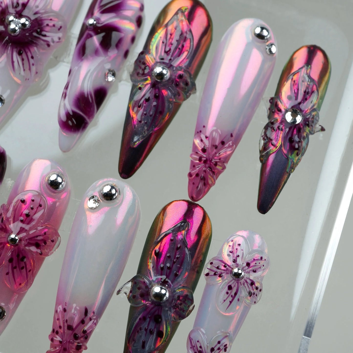 Elegant flower design nails combining soft gradients with 3D floral art and chrome embellishments