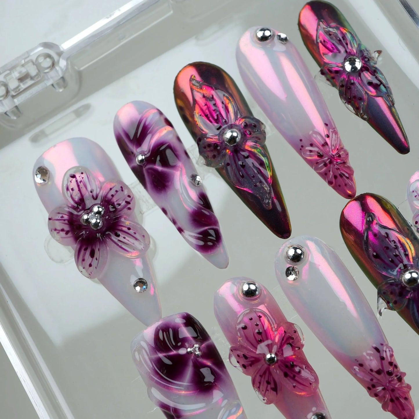 Luxurious flower design nails with mirrored effects, sculpted petals, and high-gloss finishes for a statement look