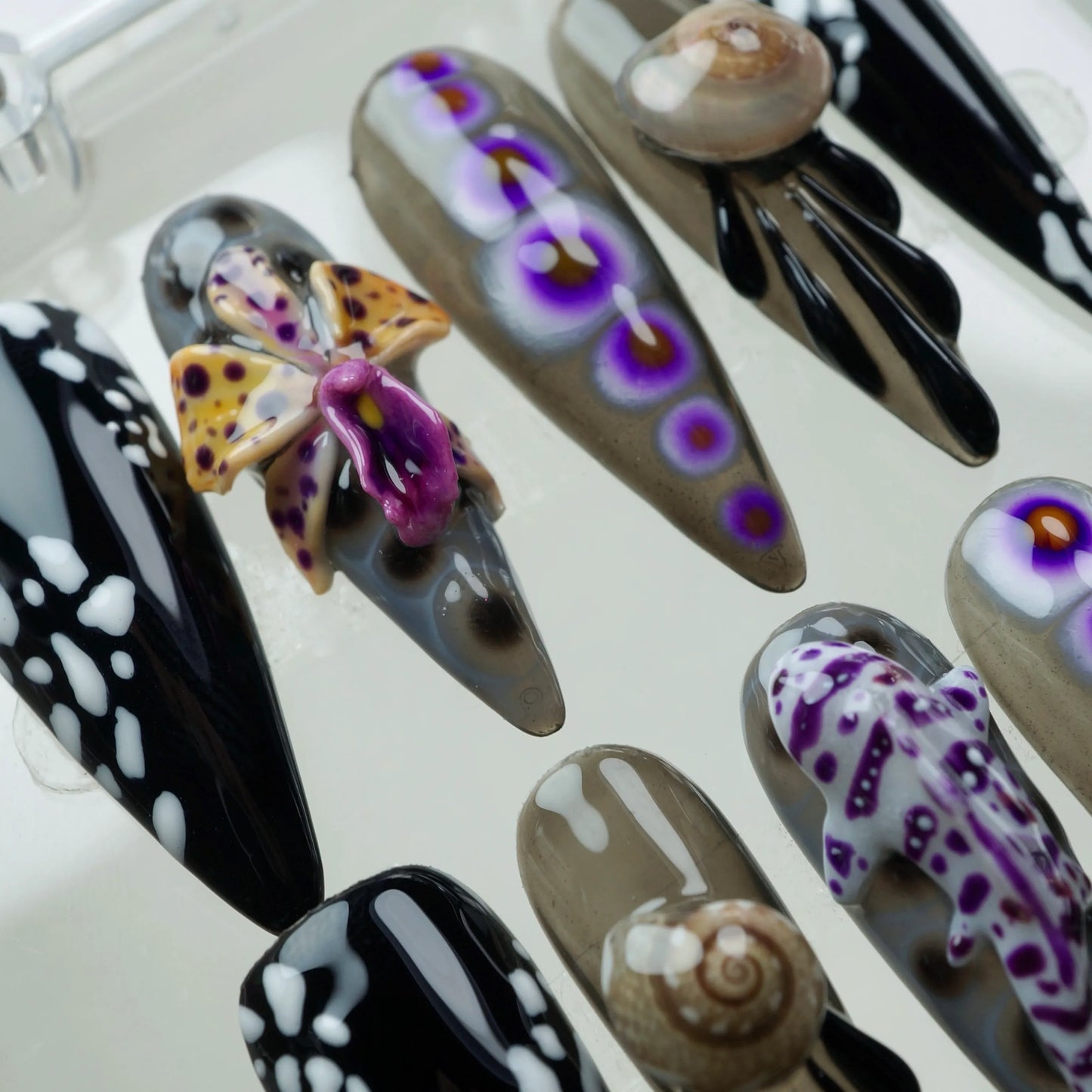 Statement summer nails with ocean-inspired creatures and bold monochrome patterns, perfect for a unique beach look.