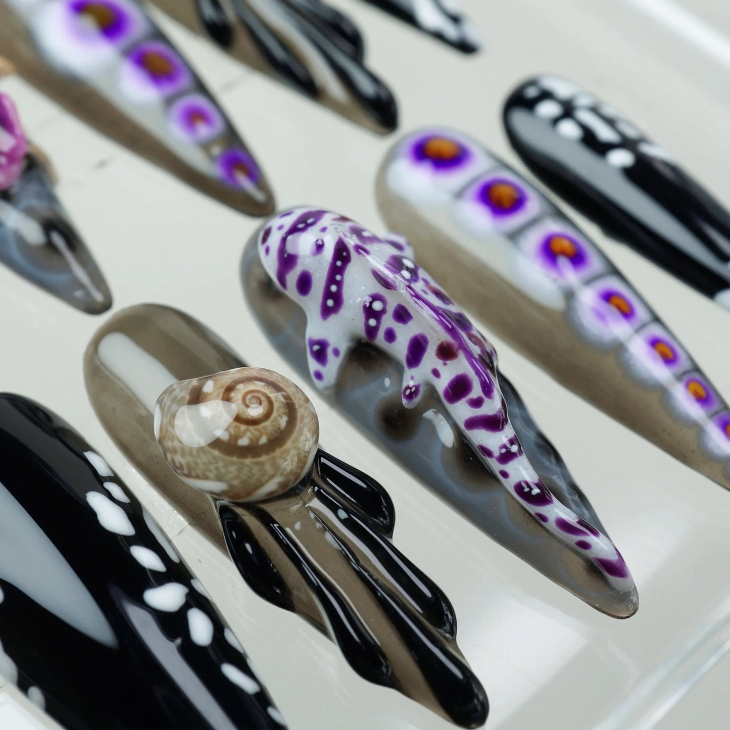 Creative summer nails featuring deep-sea animal art, including realistic 3D elements and vibrant purple accents.