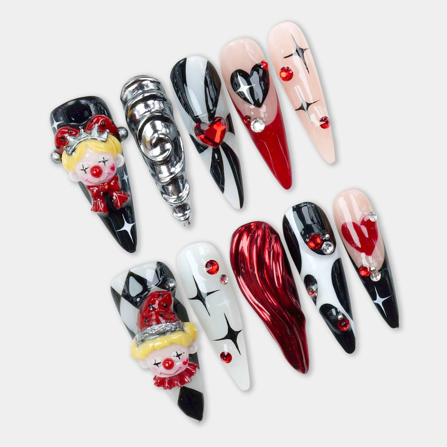 Bold clown nails by Donailsart, featuring 3D clown faces, diamond patterns, and heart accents in red, black, and white tones.