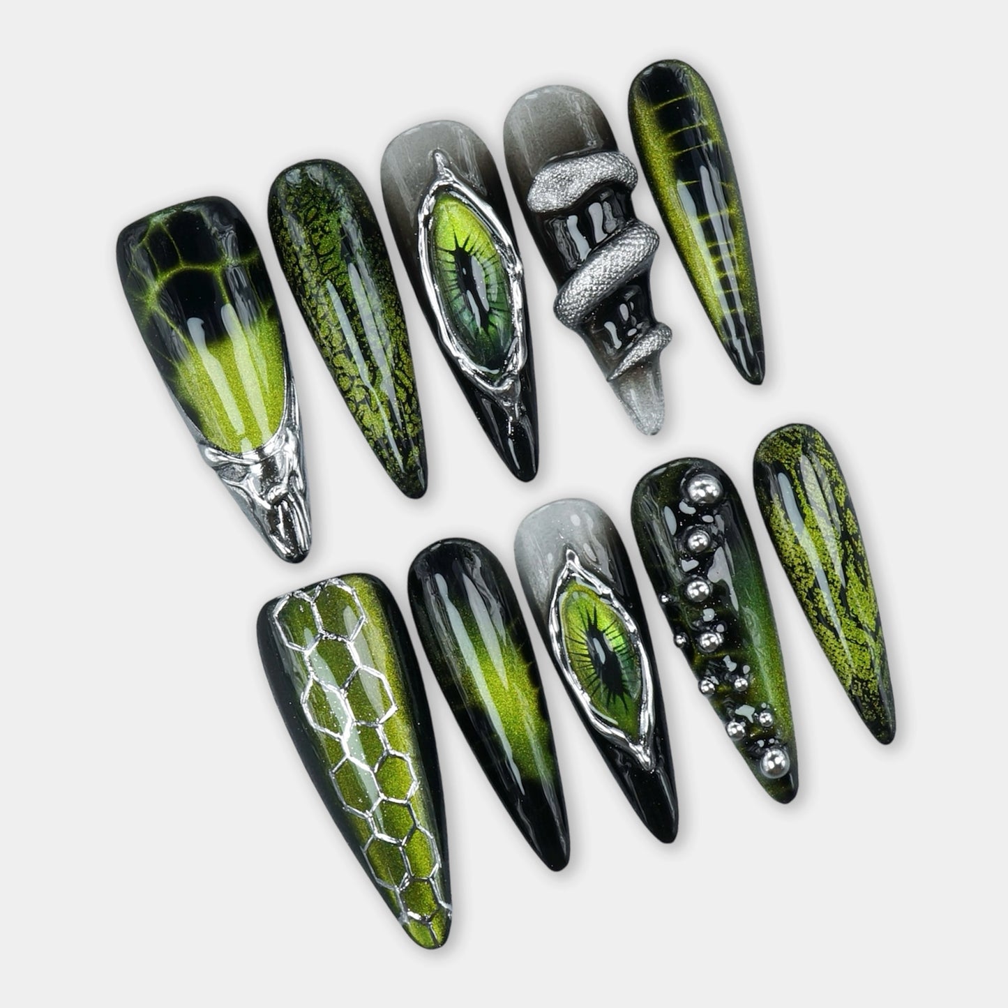 Cat-eye nails design with green magnetic shimmer, reptilian eye accents, and snake-scale textures by Donailsart