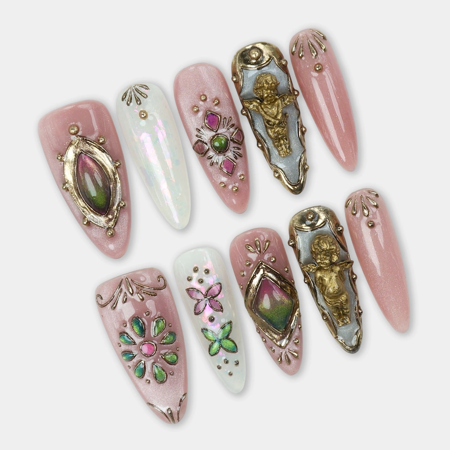 Elegant press-on nails with blush pink base, embellished with vintage gold angel charms, iridescent gems, and intricate floral and butterfly accents.