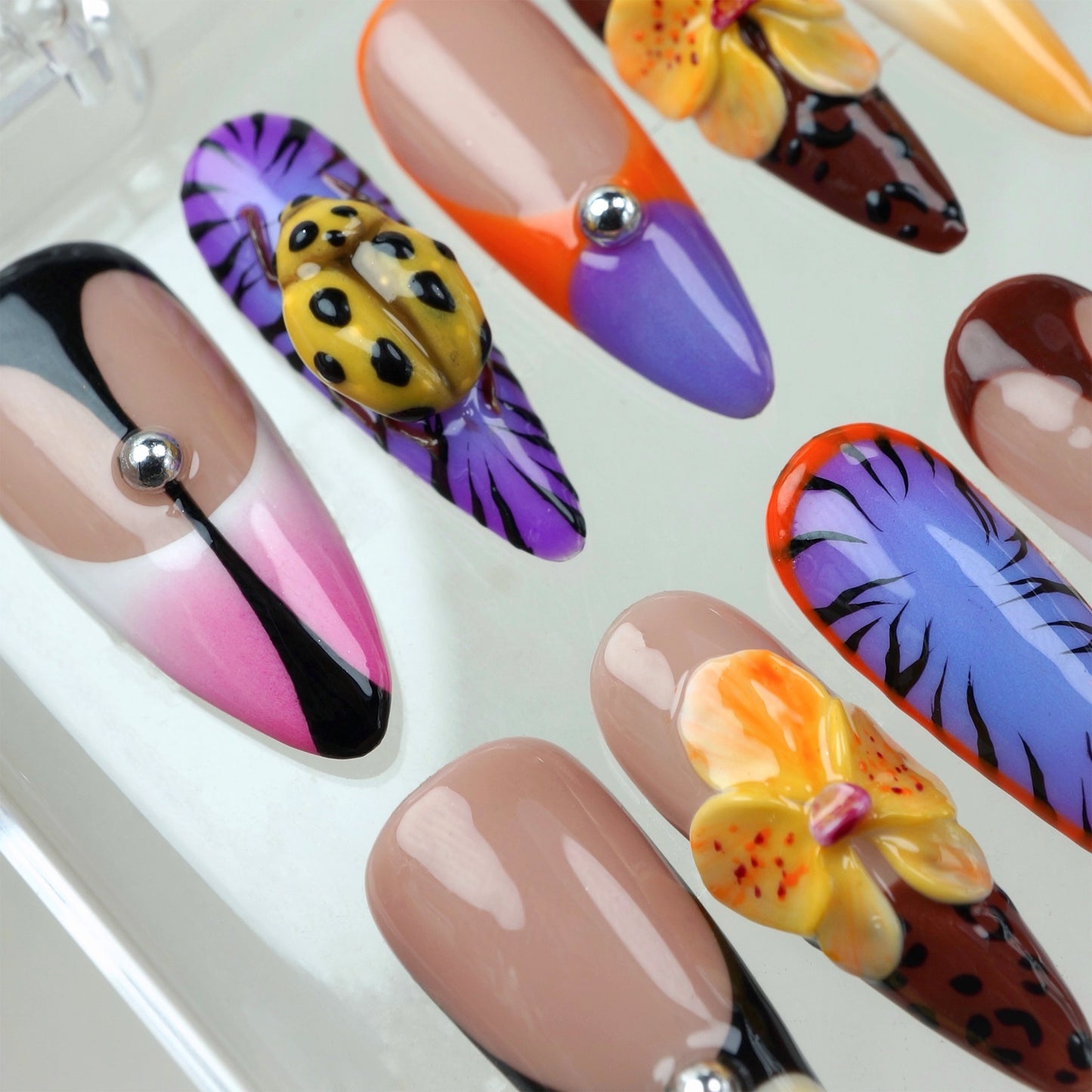 Donailsart press-on nails with tropical flowers, leopard prints, and juicy fruit textures in a bold summer palette