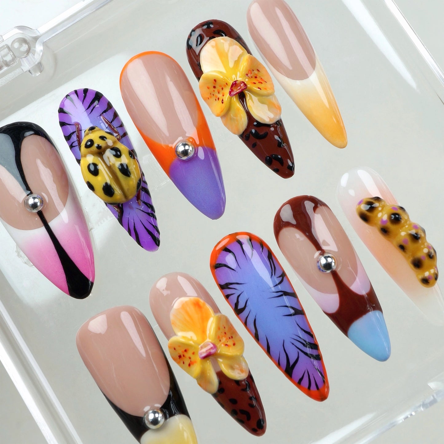 Donailsart press-on nails with tropical flowers, leopard prints, and juicy fruit textures in a bold summer palette