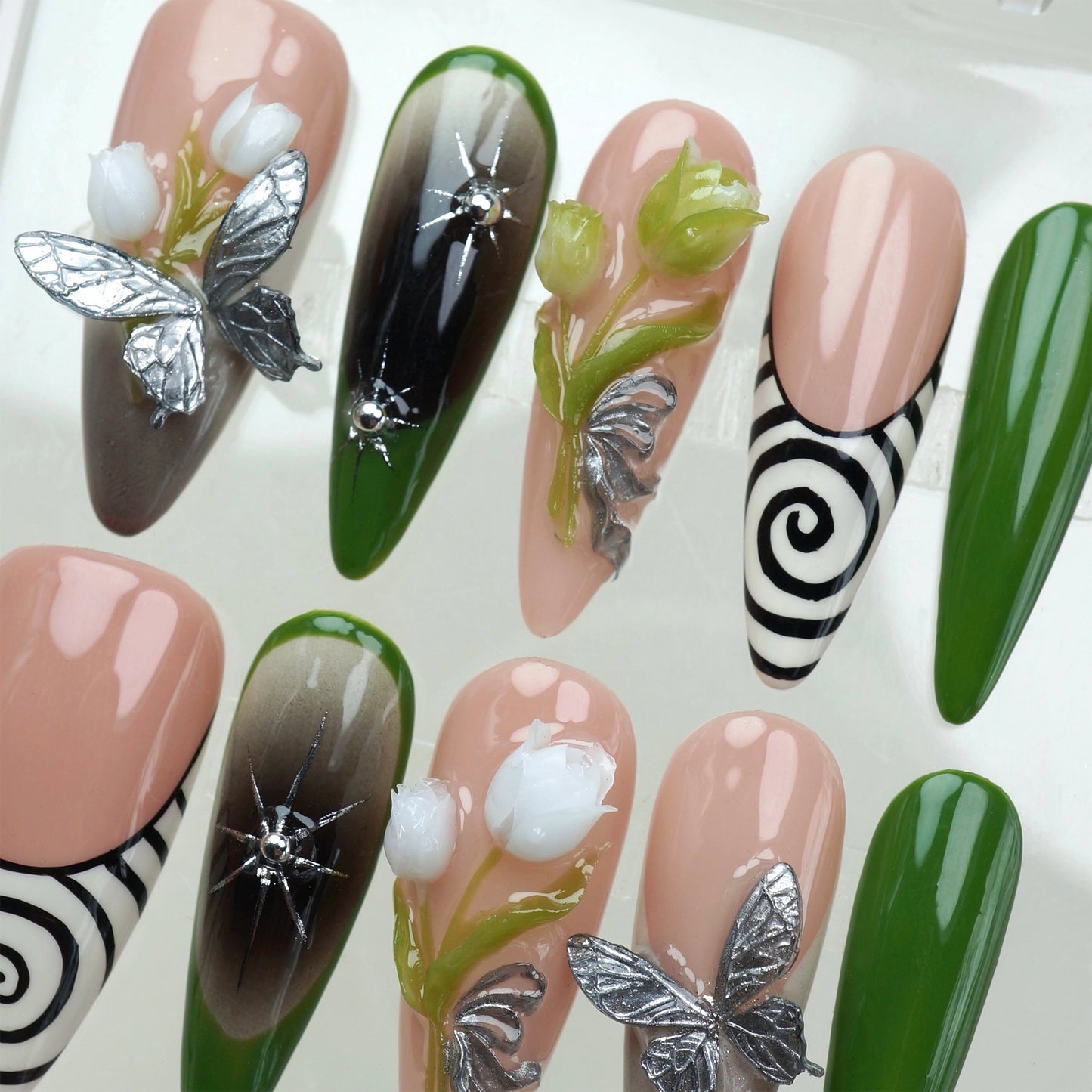 Whimsical flower nails featuring blooming buds, fantasy butterflies, and enchanting swirls in earthy tones