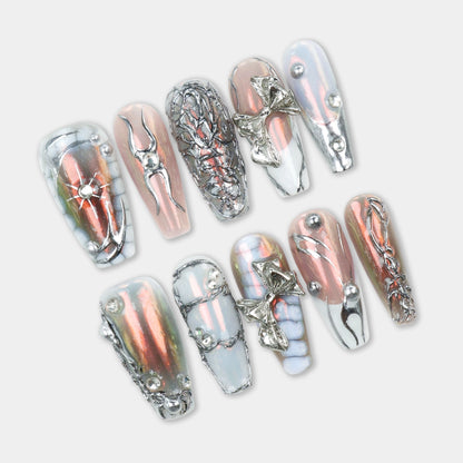 Press-on nails with a blend of chrome pink, silver accents, and 3D metallic embellishments, including bows and geometric detailing.