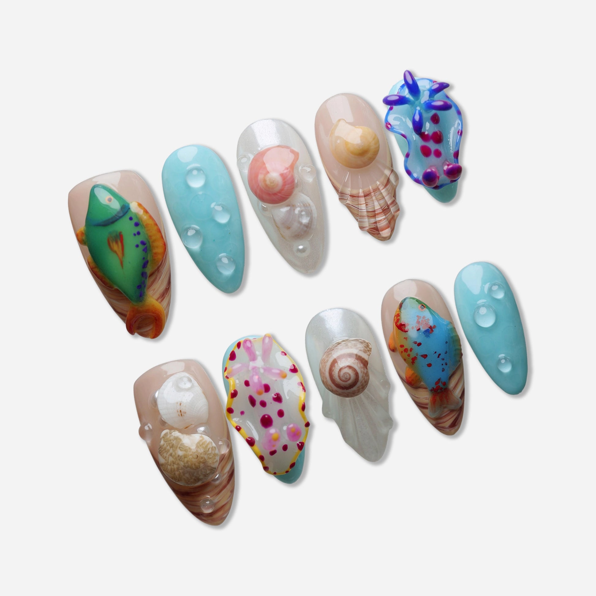 Set of decorative nail art with sea-themed designs on a white background
