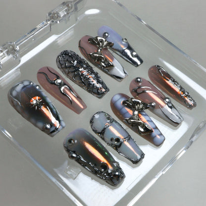 Chrome-effect press-on nails with gradient shimmer and silver 3D accents, a statement design by Donailsart.