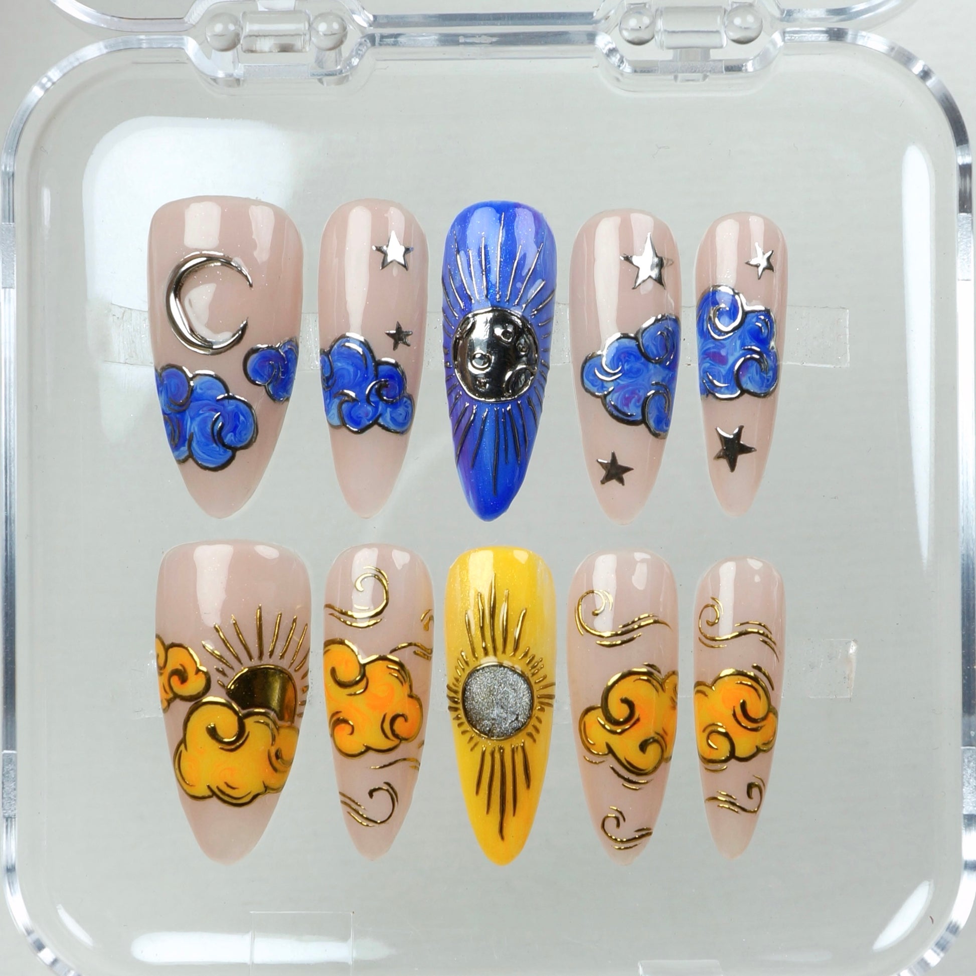 Ethereal nails that blend dreamy sky motifs—silver moons, radiant suns, and swirling clouds on a neutral backdrop.