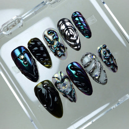 Galactic-inspired press-on nails featuring multichrome finishes, jelly-like swirls, and futuristic silver accents.