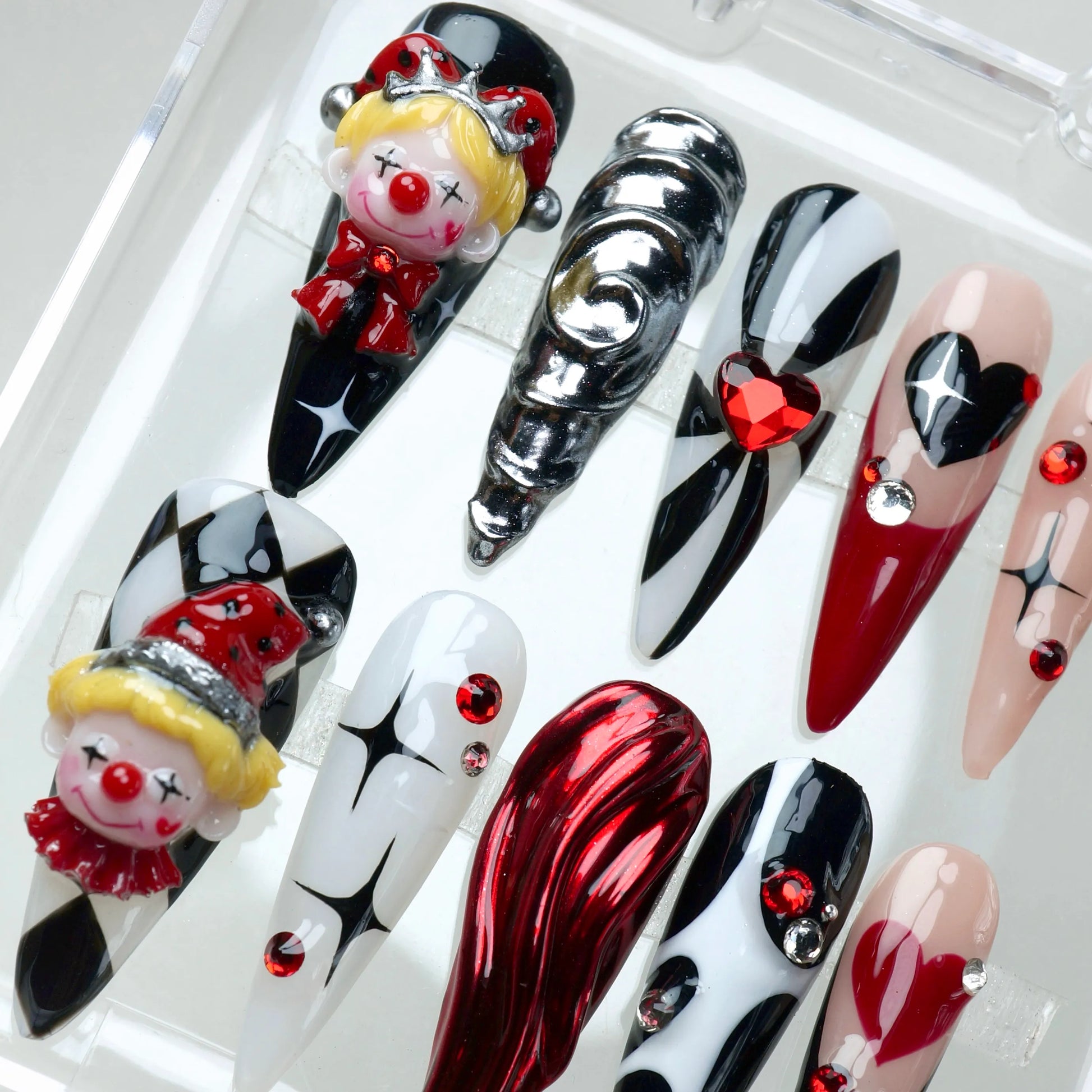 Clown nails with 3D elements, heart tips, and red rhinestones – handcrafted by Donailsart.