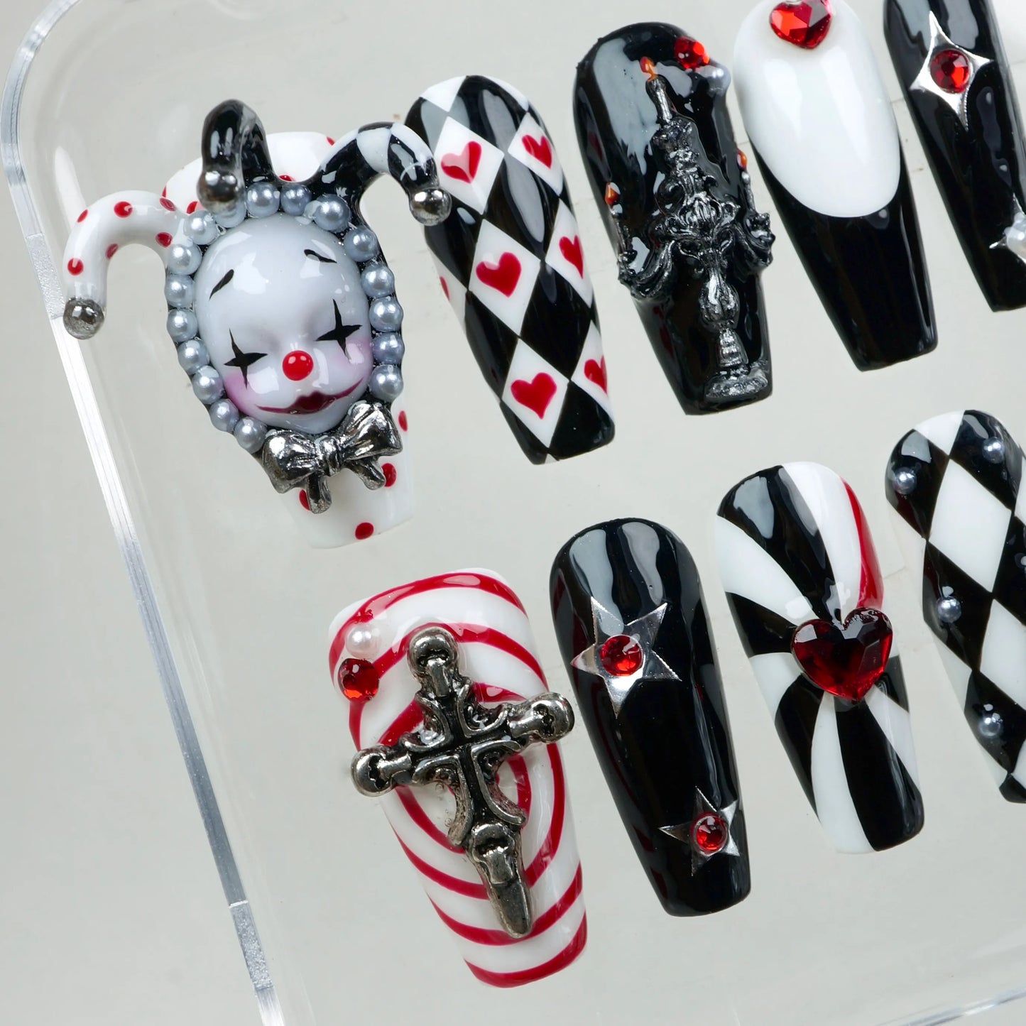 Donailsart press-on nails with circus gothic flair – featuring diamonds, hearts, and a statement clown piece.
